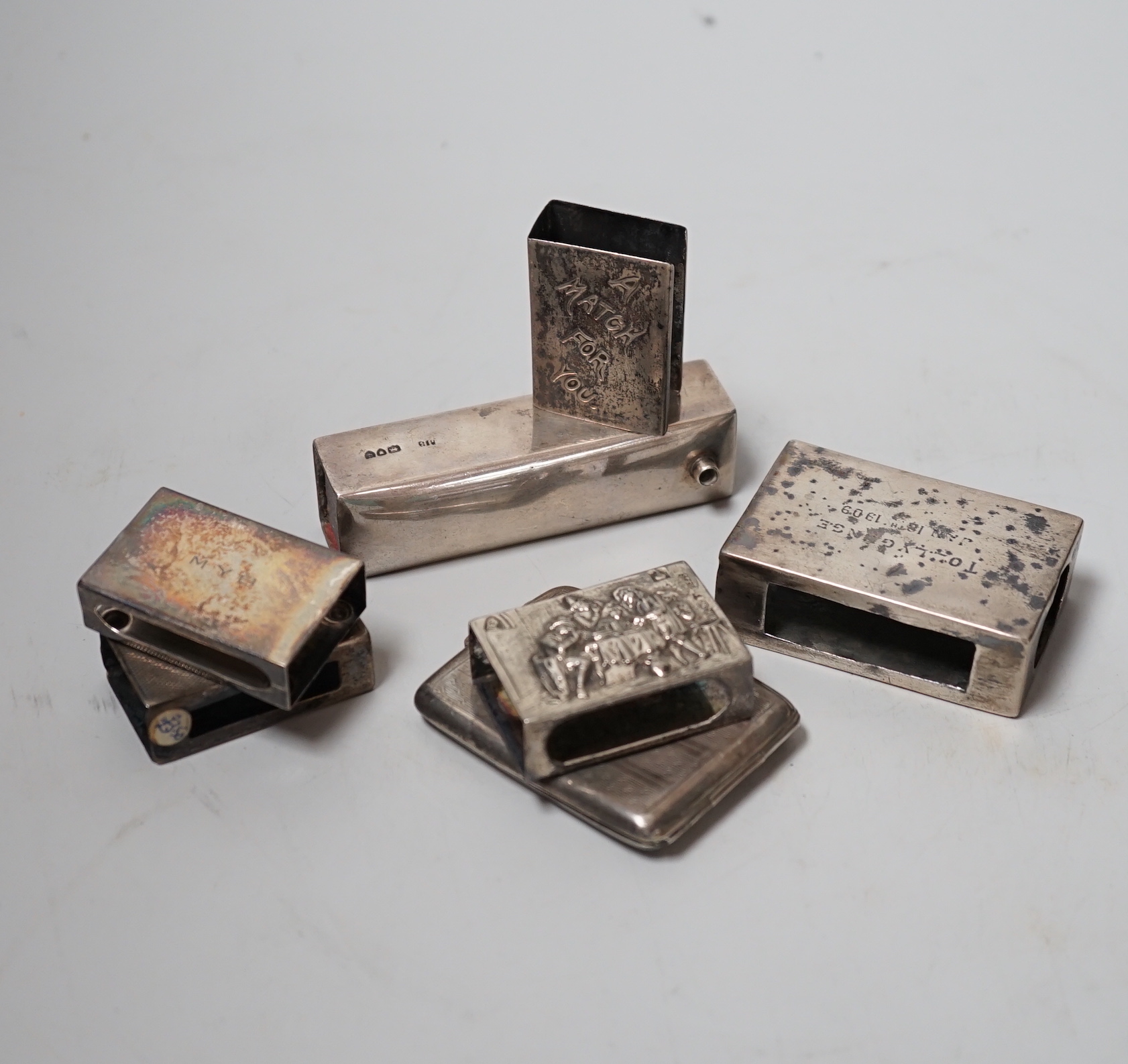 Five assorted mainly early 20th century silver matchbox sleeves and two other items including a matchbook case.